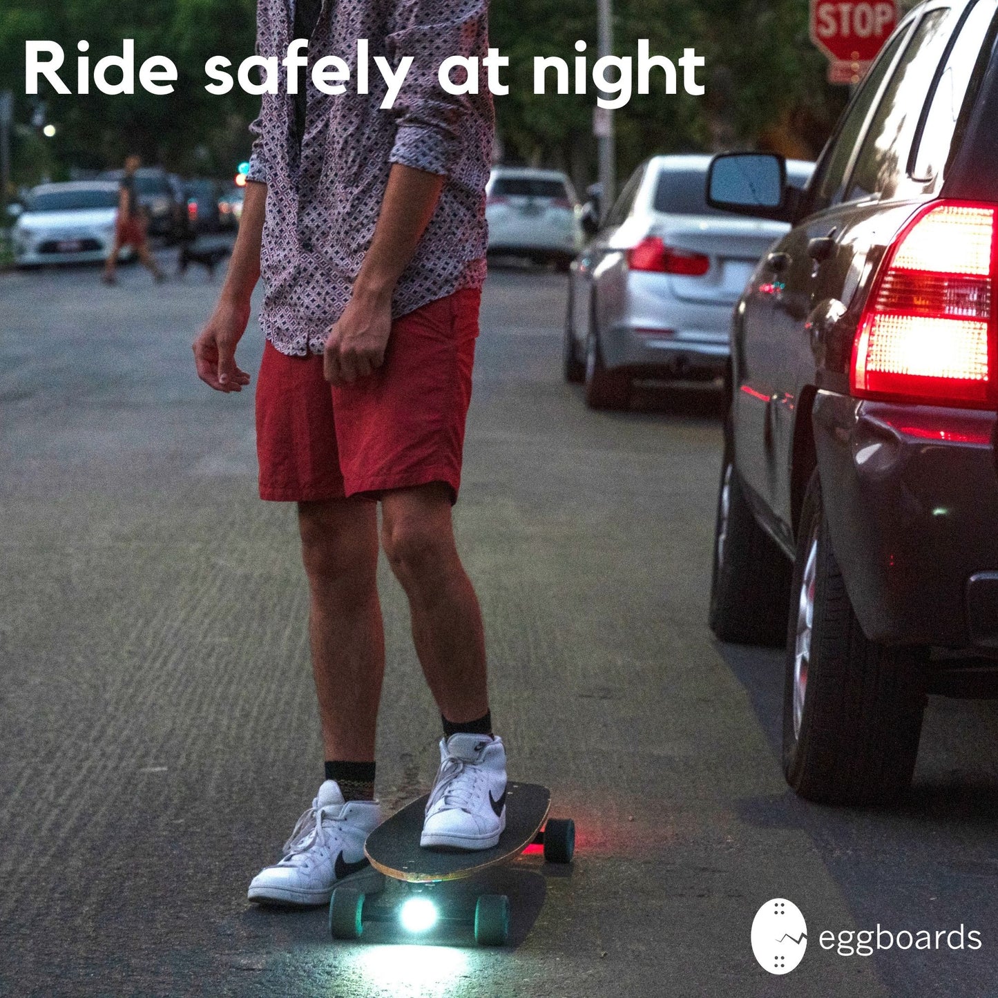 Skater riding at night with illuminated white and red LED skateboard lights for enhanced visibility and safety. The bright lights shine on the path ahead, ensuring a clear view while adding a stylish touch to the skateboard. Perfect for nighttime rides, these LED skateboard lights are essential for skaters looking to enjoy their sessions safely in low-light conditions.
