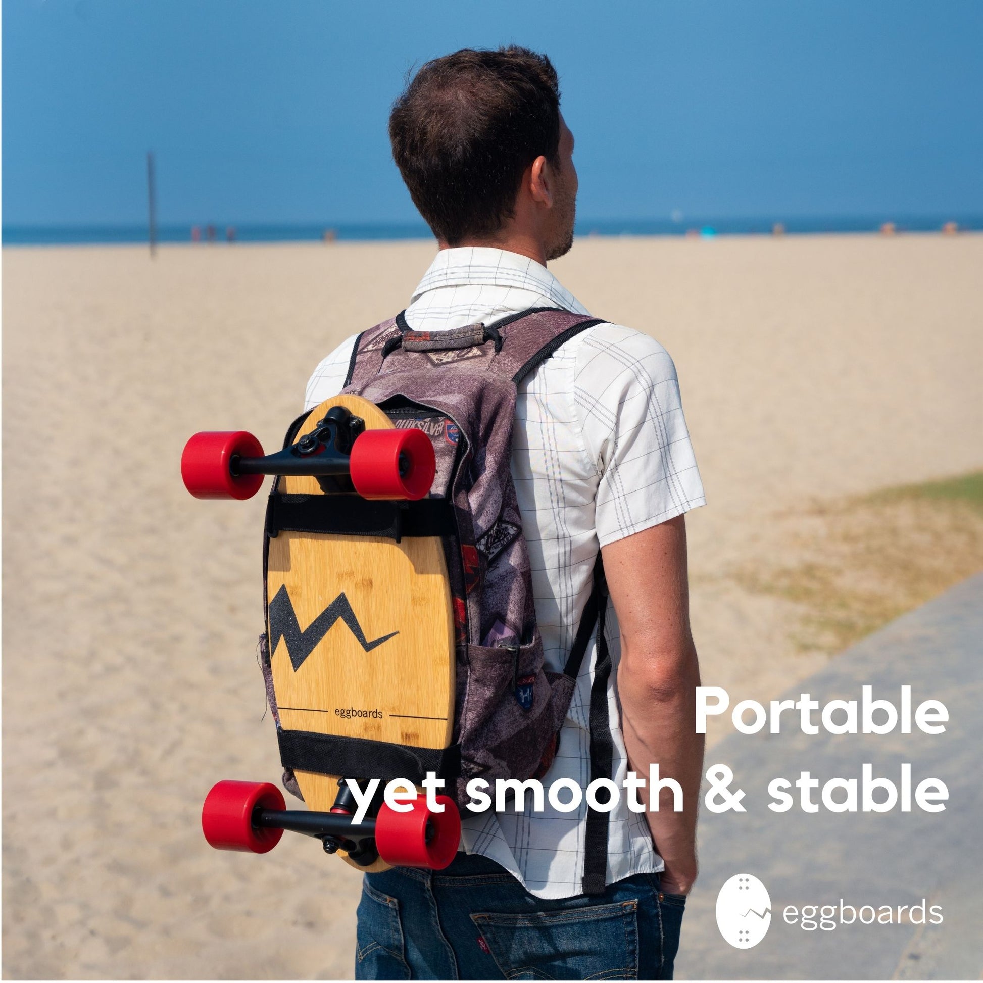 A skater on a sunny day with a skateboard backpack, standing on the beach with an Eggboard Mini Cruiser strapped to his bag, emphasizing the board's portability and perfect design for coastal lifestyles.