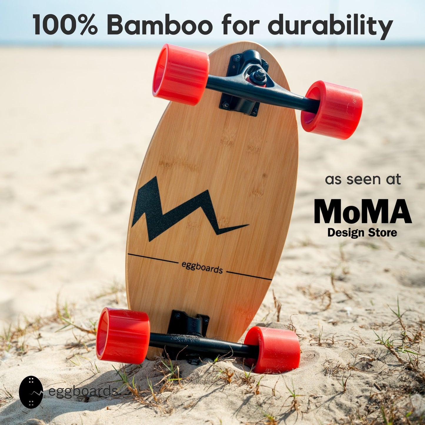 A closeup of an Eggboard Bamboo Skateboard with red wheels and unique crack-shaped griptape resting on the sand at Venice Beach, California, featuring overlays that highlight its 100% bamboo construction and recognition at the MoMA Design Store.