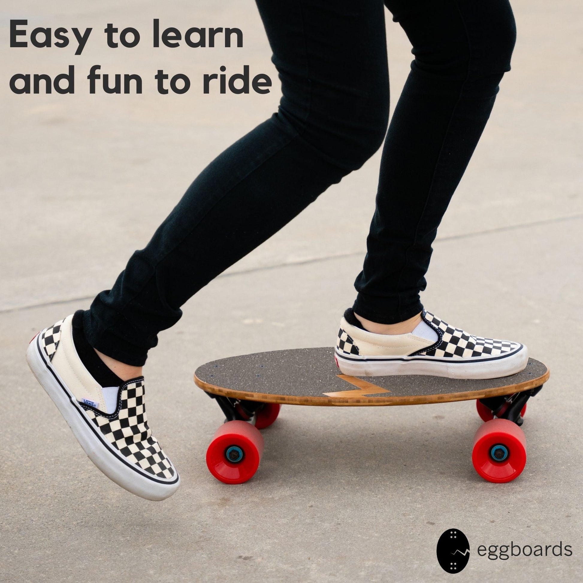 A closeup of a girl wearing checkered Vans shoes riding an Eggboard Mini Longboard Cruiser with red wheels, showcasing the board's stylish design and functionality for urban skateboarding.