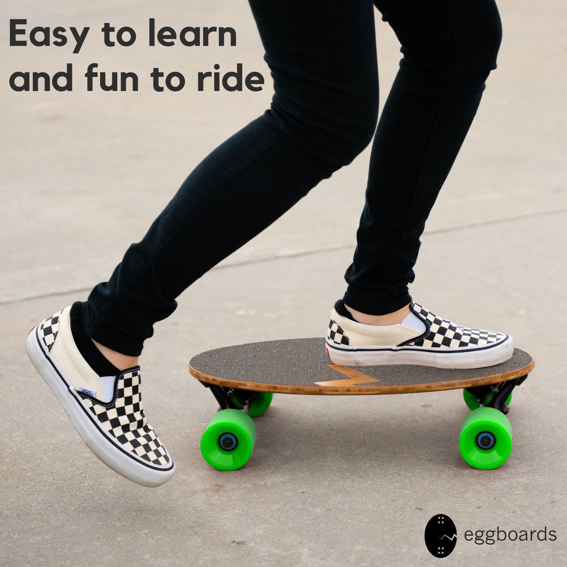 A closeup of a girl wearing checkered Vans shoes as she rides an Eggboard mini longboard cruiser with green wheels. The overlay text reads "easy to learn and fun to ride," showcasing the board's user-friendly design.