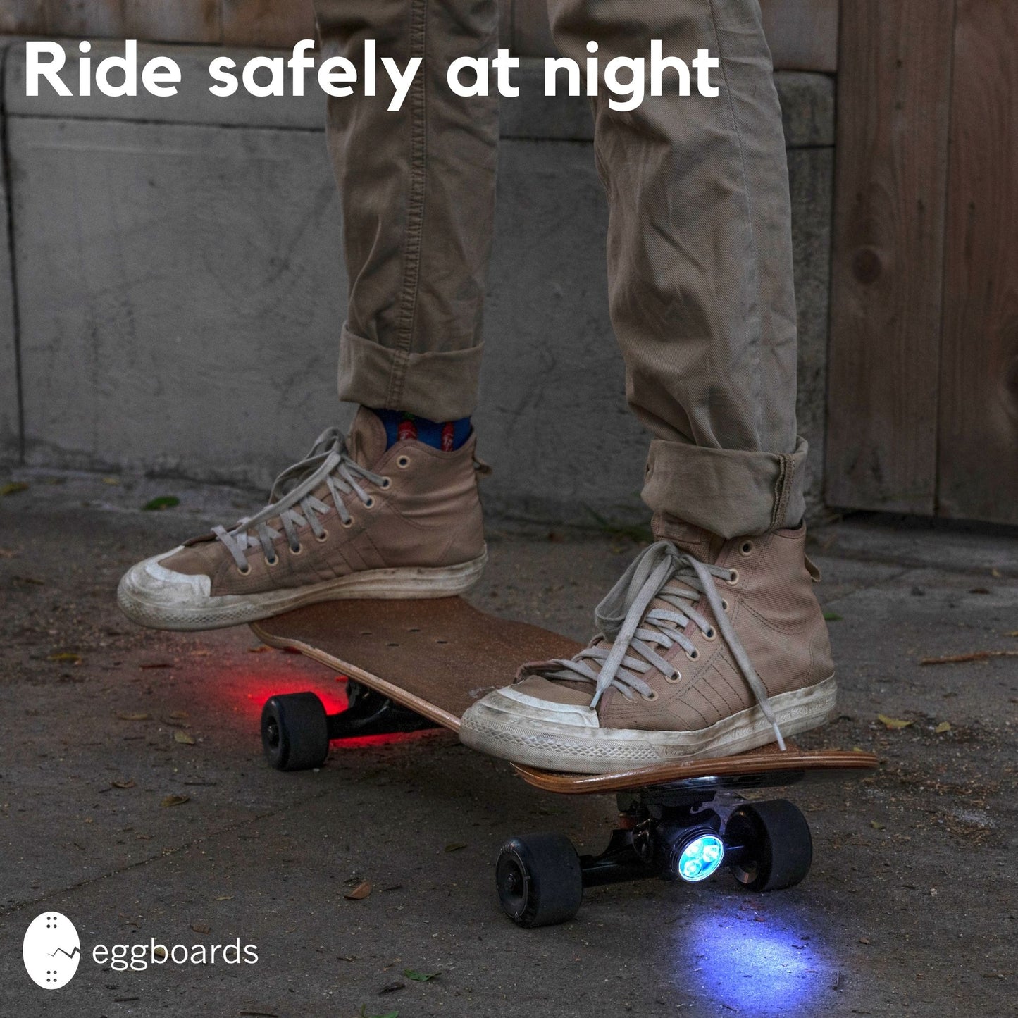 Skaters riding at night with blue-red LED longboard skateboard lights installed for enhanced visibility and style. The vibrant lights illuminate the path, ensuring safety during nighttime rides while adding a cool aesthetic to their skateboards. These longboard skateboard lights are perfect for cruising in urban environments, making them a must-have for anyone who enjoys skating after dark.