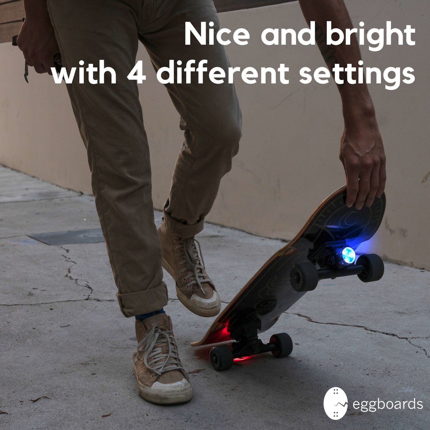 Skater preparing to drop the board and start cruising, with the Blue-Red LED lights illuminated for enhanced visibility during nighttime rides.